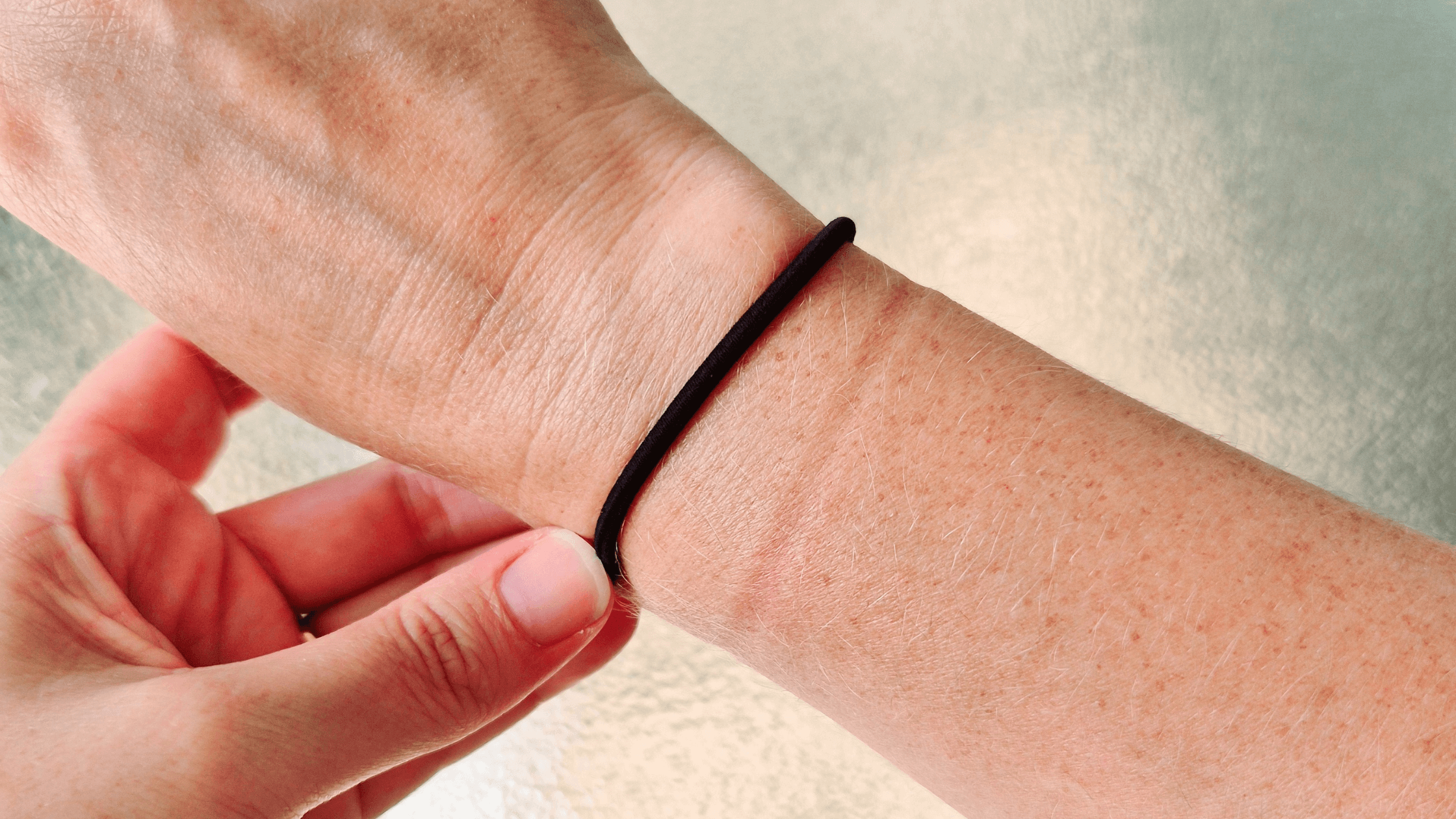 Hair tie on a wrist with a red tight indent