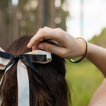 Gypsea loop hair tie bangle with black hair tie holds your hair tie off your wrist. Swap out hair tie colours to match your outfit or mood