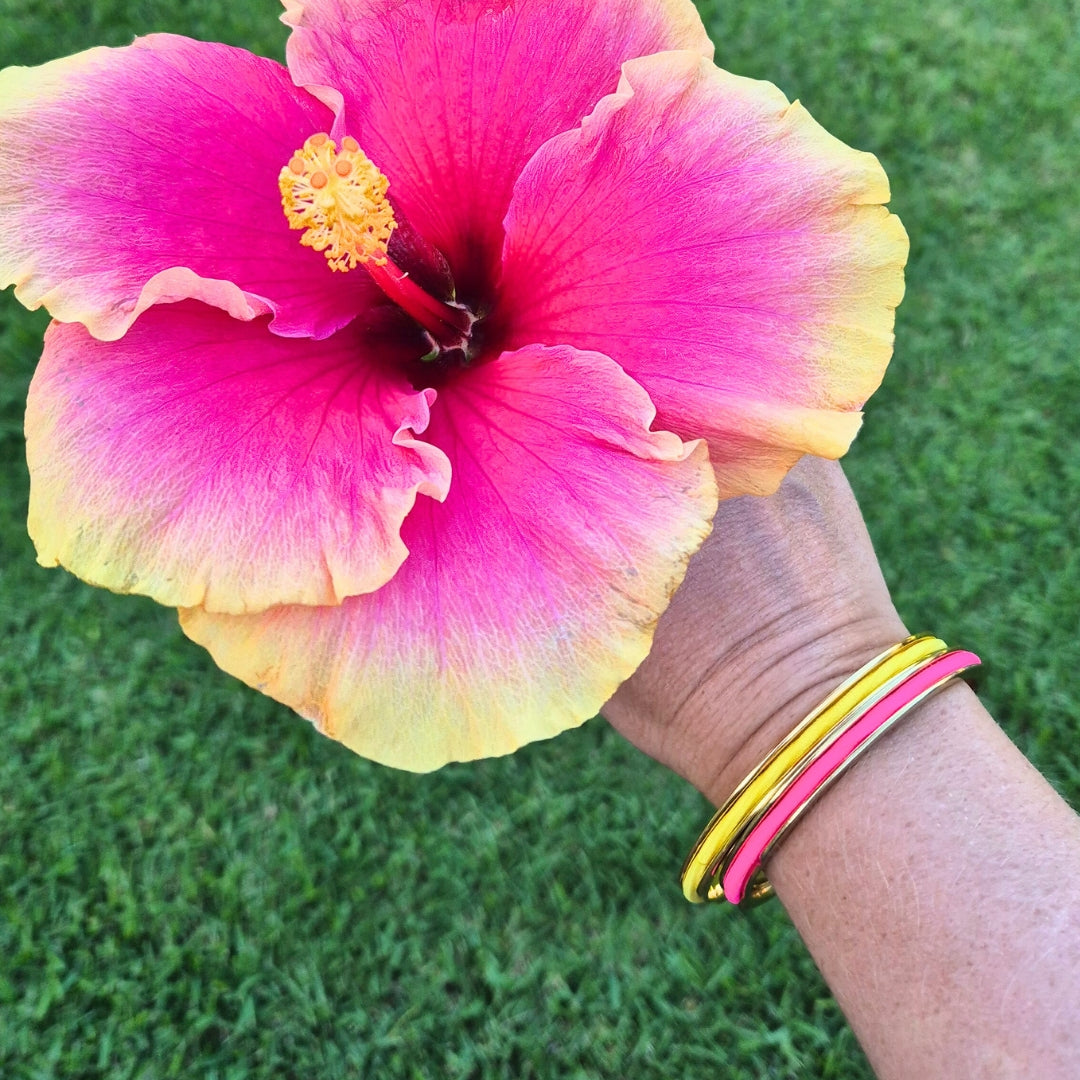 Pink and yellow hair ties in a hair tie bangle by Gypsea Loop