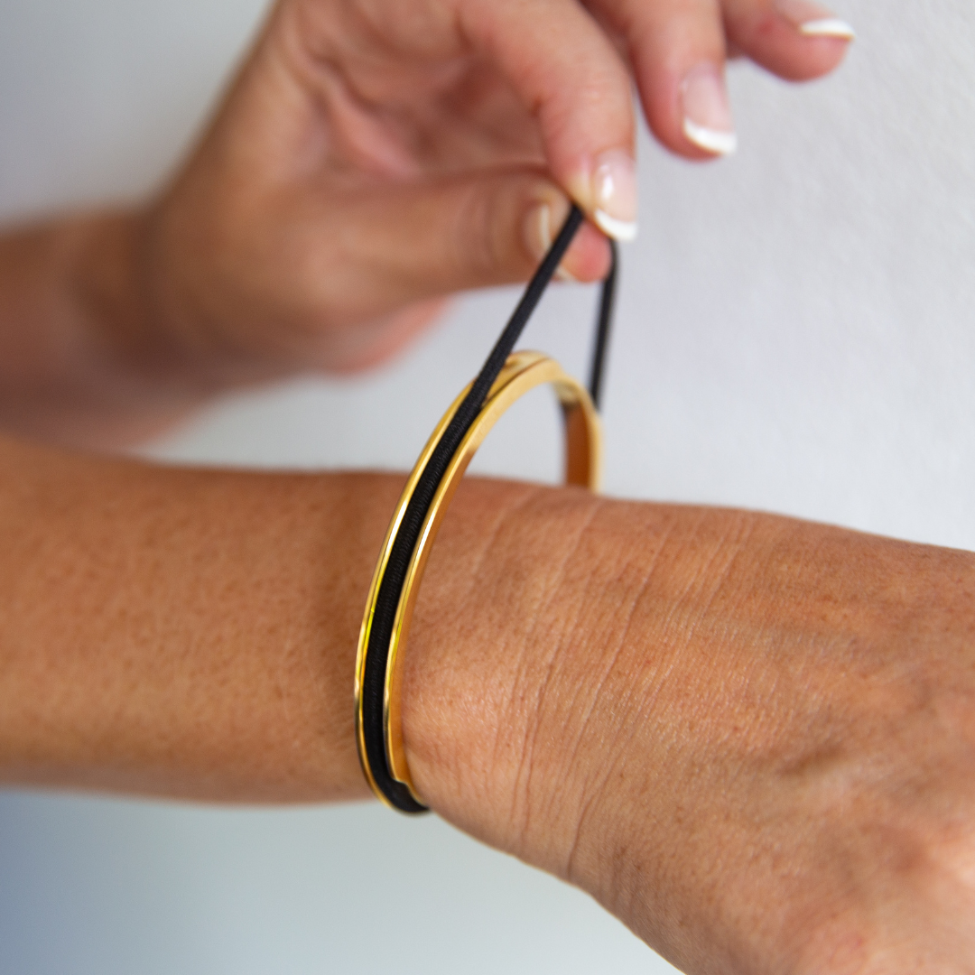 Gypsea loop hair tie bangle holds your hair tie in a secret groove. Available in Gold and Silver