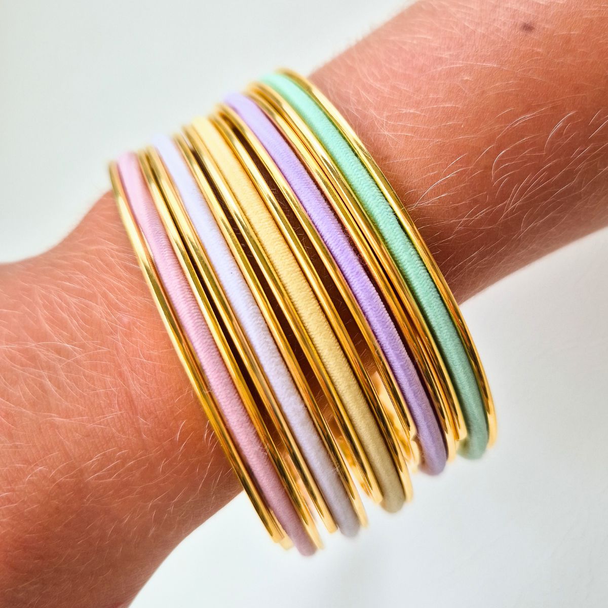 Gypsea Loop bangle with pastel hair ties stacked