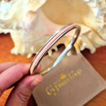 Silver Gypsea Loop bangle with pink hair tie