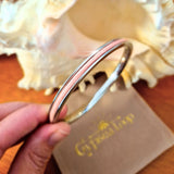 Silver Gypsea Loop bangle with pink hair tie