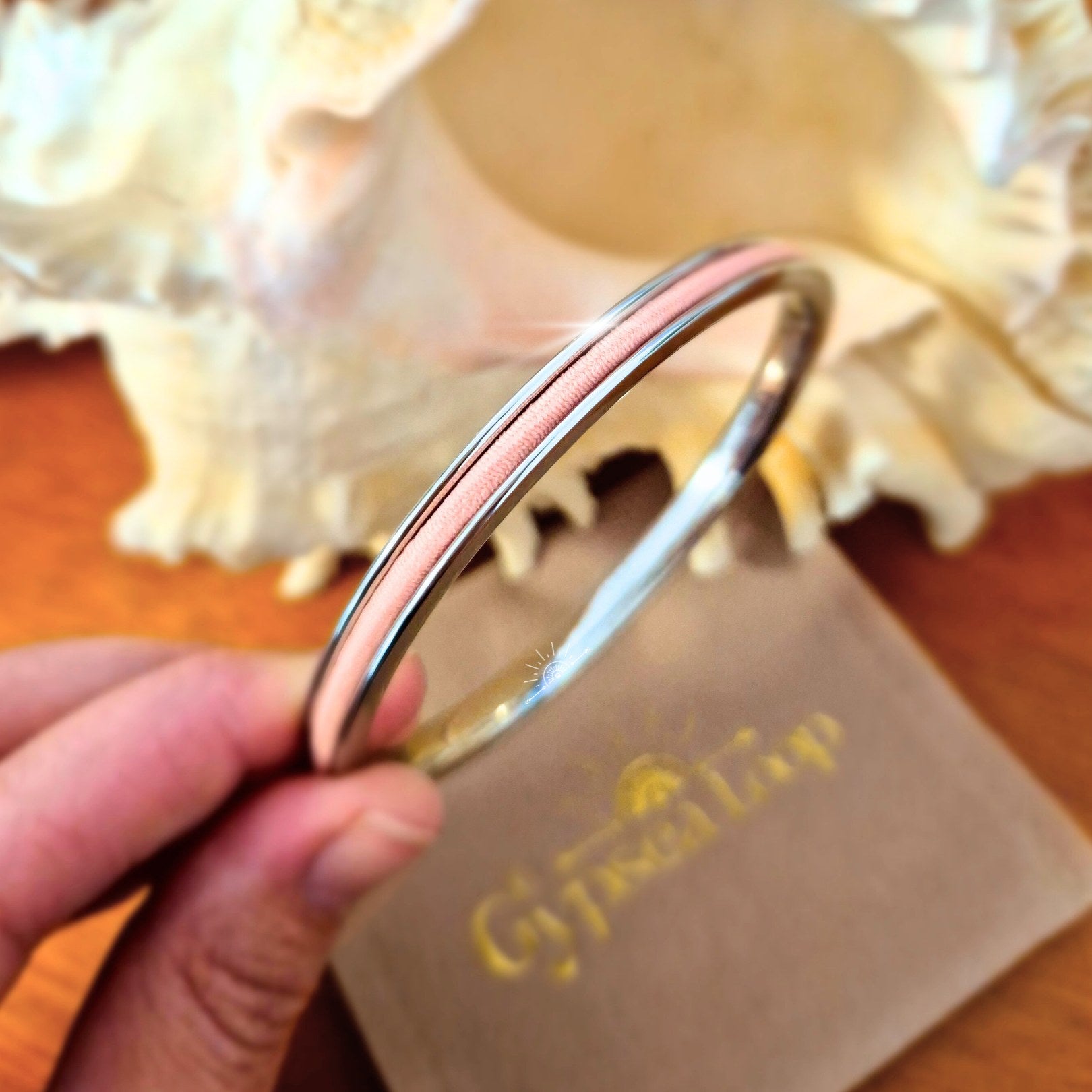 Silver Gypsea Loop bangle with pink hair tie